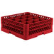 A red Vollrath plastic glass rack with 16 compartments.