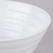 A close up of a white 10 Strawberry Street Swing cereal bowl with a white rim.