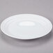 A white 10 Strawberry Street Swing porcelain plate with a rim.