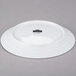 A white 10 Strawberry Street Swing porcelain plate with a black rim.