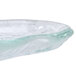 A close-up of a 10 Strawberry Street Ocean Clear glass elliptical bowl with a wavy edge.
