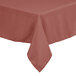 A square mauve tablecloth with a red border on a table.