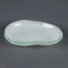 A white opal glass eliptical bowl with a green rim.