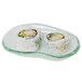 A white opal glass eliptical dish with sushi rolls on it.