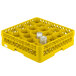 A Vollrath yellow plastic rack with 20 compartments holding glasses.
