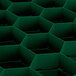 A green rectangular Vollrath Traex glass rack with hexagonal compartments.
