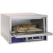 A Bakers Pride countertop oven with a pie in a tin.