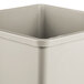 A close-up of a Rubbermaid square beige plastic liner.