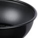A close up of a Solo black wide sauce portion cup.