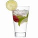 A Arcoroc highball glass of water with raspberries, mint, and lime.