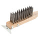 A wooden handle with metal bristles on a Thunder Group Narrow Broiler / Grill Cleaning Brush.