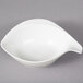 A white bowl with a handle.