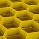 A yellow plastic Vollrath Traex glass rack with a hexagonal grid.