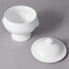 A white porcelain bowl with a lion head lid.