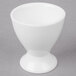 A white 10 Strawberry Street Whittier egg cup on a gray surface.