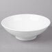 A white 10 Strawberry Street Whittier ribbed footed bowl on a gray surface.