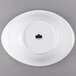 A white porcelain serving bowl with a black label.