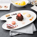 A 10 Strawberry Street white porcelain platter with a variety of desserts on it.