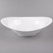 A 10 Strawberry Street Whittier white porcelain swoop bowl on a gray surface.