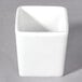 A white square tall porcelain bowl with a lid.