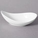 A 10 Strawberry Street Whittier white porcelain canoe tid bit bowl on a gray surface.