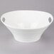 A white Oslo porcelain deep handle bowl on a gray surface.