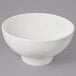 A white bowl with a ribbed design on a gray background.
