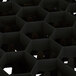 A close-up of a black Vollrath Traex glass rack with a hexagonal pattern.