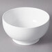 A white 10 Strawberry Street Whittier porcelain footed bowl on a gray surface.