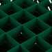 A green plastic grid with squares and holes.