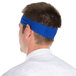 A man wearing a royal blue Headsweats headband.