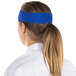 A woman wearing a royal blue Headsweats headband.