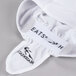 A white Headsweats chef cap with black text reading "eats" on it.