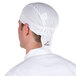 A man wearing a white Headsweats chef cap.