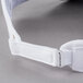 A white Headsweats visor with a white strap and metal buckle.