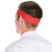A man wearing a red Headsweats headband.