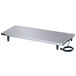 A rectangular stainless steel table with a power cord.
