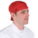 A man wearing a red Headsweats chef cap.
