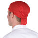 A man wearing a red Headsweats chef cap.
