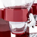 A red and clear Zevro double dry food dispenser.