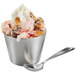 A double wall stainless steel round sauce cup filled with ice cream with a spoon.