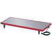 A red rectangular metal heated shelf with a cord attached.