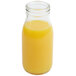 An American Metalcraft glass milk bottle filled with orange juice.
