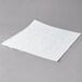 White square filter paper for fryer oil on a gray surface.