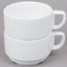 A stack of Arcoroc white porcelain cups with handles.