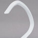 A white plastic curved object with a white plastic handle.
