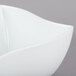 An American Metalcraft Prestige white wave porcelain bowl on a gray surface.