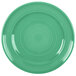 A green Tuxton Concentrix china plate with a white spiral pattern.