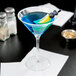 A blue drink with a lemon slice in a Stolzle New York martini glass.