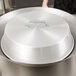 A Town aluminum wok cover on a large wok.